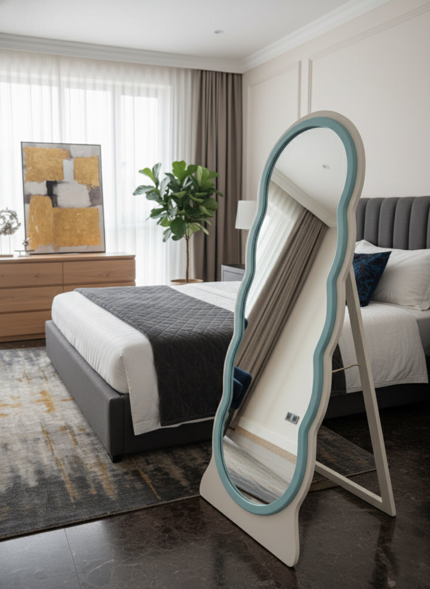 Side view of the Adooch wavy freestanding mirror showing its sturdy stand, placed in a bedroom